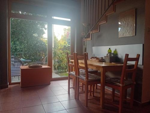 a kitchen with a table and chairs and a window at Útulné zátišie v zoborskom dome in Nitra