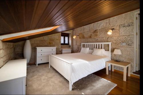 a bedroom with a white bed and a wooden ceiling at Villa - 5 Bedrooms with WiFi - 7841 in A Estrada