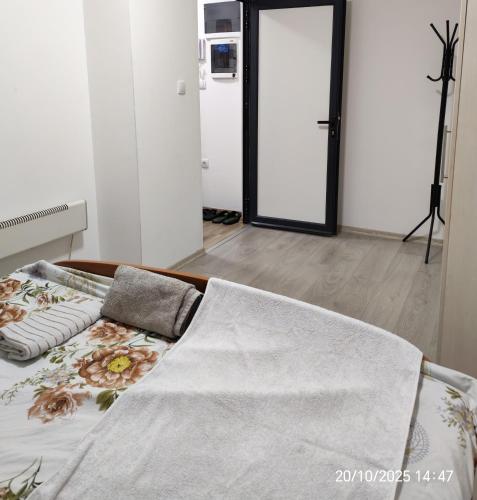 a bedroom with a bed with a blanket on it at Junona Magenta in Prokuplje