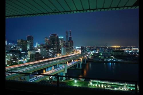 a view of a city at night with a bridge at Hotel Okura Kobe in Kobe