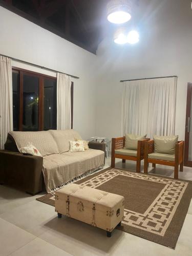 a living room with a couch and a table at Águas da Serra Condomínio in Bananeiras