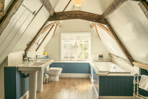 a bathroom with a sink and a toilet and a tub at Fritton Lake - The Clubhouse in Great Yarmouth