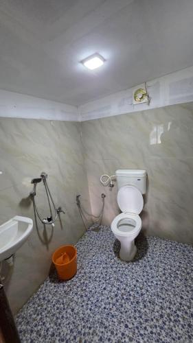 a bathroom with a toilet and a sink at Valley Homestay in Devikolam