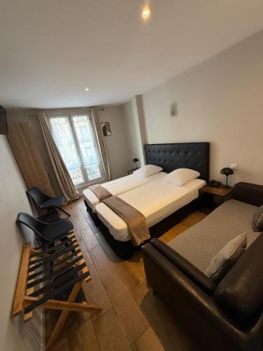 a large bedroom with a bed and a couch at LAFAYETTE HOTEL in Paris