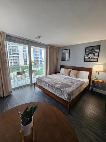 a bedroom with a large bed and a large window at Sunny Isles Oceanfront Apartment for Two in Sunny Isles Beach