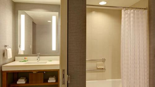a bathroom with a sink and a shower curtain at Hyatt Place Phoenix-North in Phoenix