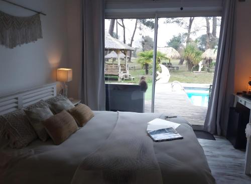 a bedroom with a bed with a book on it at Villa Saint Barth in Gujan-Mestras