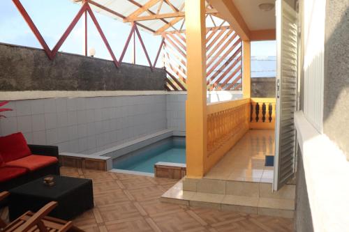 a swimming pool on the roof of a building at Océan Voyages Mitsamihouli in Mitsamiouli