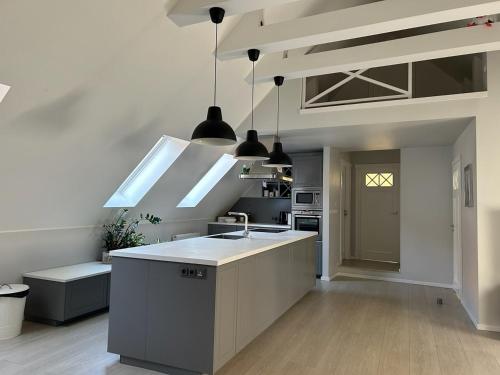 a kitchen with a sink and a counter top at Apartamenty Smile 2 in Grudziądz