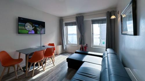 a living room with a couch and a table at KCM Urban Retreats in Cobh