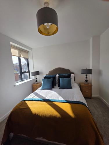 a bedroom with a bed with a yellow and blue blanket at Suite Bowl in Exmouth