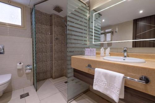 a bathroom with a sink and a shower and a toilet at Sumou Al Khobar Corniche in Al Khobar