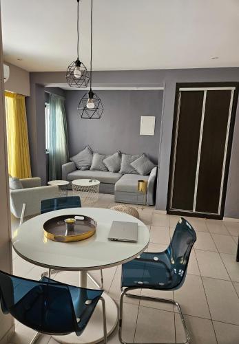 a living room with a table and chairs and a couch at Beachfront Amazing New Apartment in Limassol
