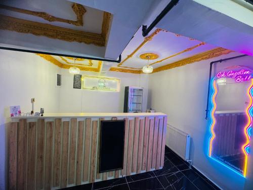 a bar in a restaurant with a neon sign at Grand Süleymaniye Hotel in Istanbul