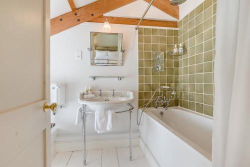 a bathroom with a sink and a bath tub at 6 Bed in Tresillian oc-t32987 in Newlyn East