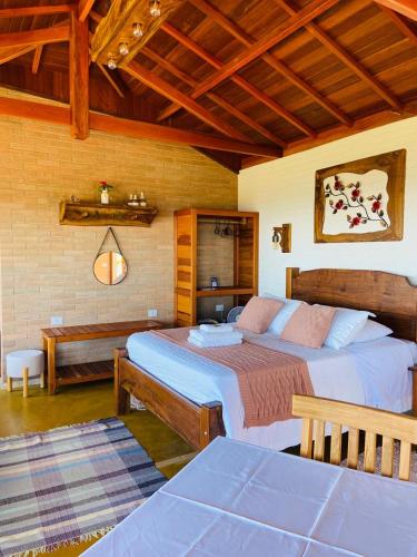 a bedroom with two beds in a room at Chalés Terras Altas in Gonçalves
