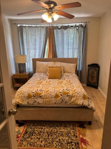 a bedroom with a bed with a ceiling fan at designer abode condo min to Manhattan in jersey city in Jersey City
