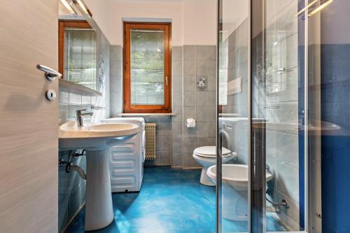 a bathroom with a sink and a toilet and a shower at Casa Tuly in Brenzone sul Garda