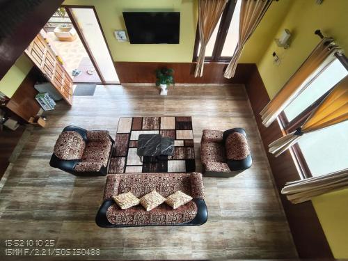 a living room with a chess game on the floor at Pleasant Stay Coonoor-A Serene Hillside Retreat in Coonoor