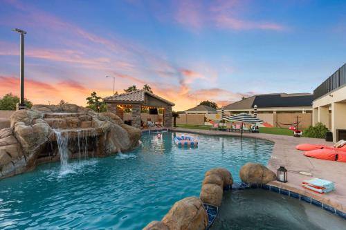 a pool with a waterfall and a water slide at Luxury 6BR Retreat - Pool BBQ Theater and Games in Lemontree