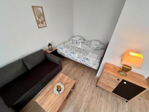 a living room with a couch and a bed at Apartmán Dona in Veľký Meder