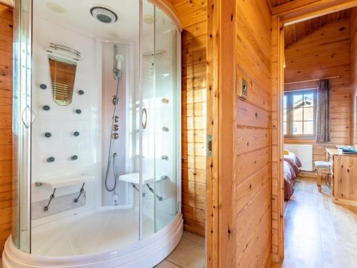 a bathroom with a shower in a wooden wall at 2 Bed in Clovelly 00361 in Clovelly