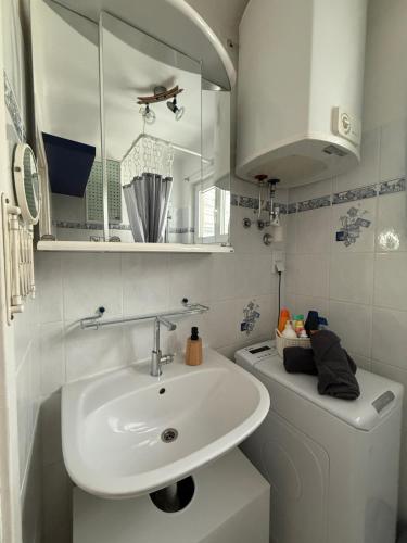a white bathroom with a sink and a toilet at Casa Lauda in Pillichsdorf in Pillichsdorf