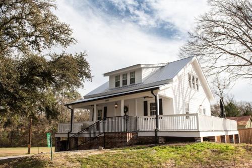a white house with a black roof at Little Noone in Jackson