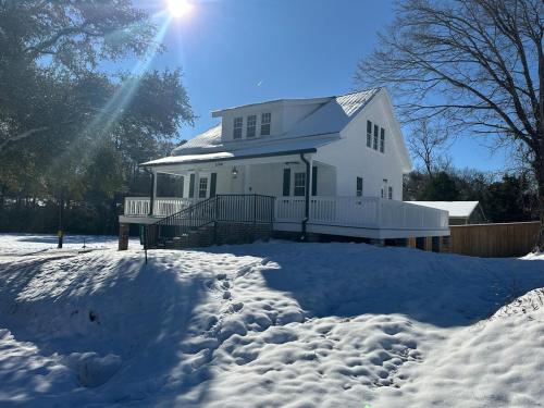 a white house with snow in front of it at Little Noone in Jackson