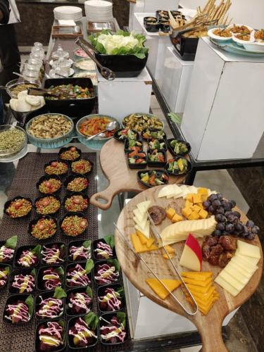 a buffet with many different types of food on a table at Amritara Aura Resort & Spa in Mandrem