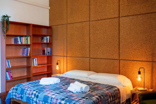 a bedroom with a bed with two towels on it at Villa d'Este - Historic City Villa with WiFi & Air Conditioning in Ferrara