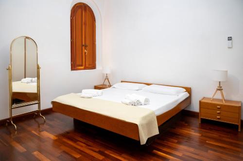 a bedroom with a large bed and a mirror at Villa d'Este - Historic City Villa with WiFi & Air Conditioning in Ferrara