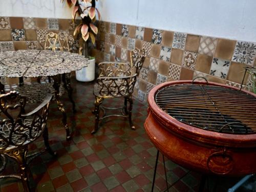 a restaurant with tables and chairs and a grill in a room at La Casa De Don Rámon in Guadalajara