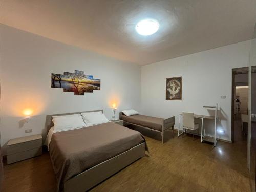a bedroom with a bed and a desk and a table at La Petite Maison in Augusta