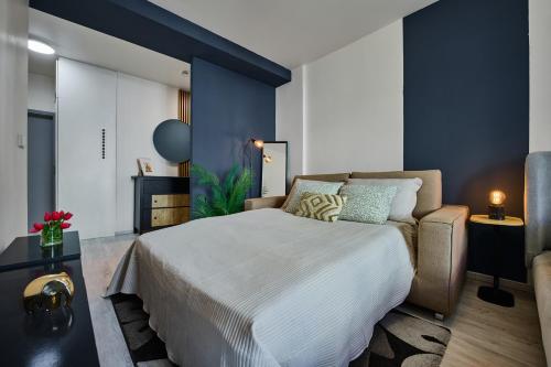 a bedroom with a bed and a couch at Apartment Mostecka in Prague