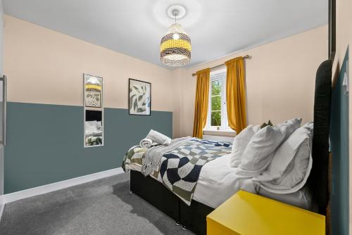 a bedroom with a bed and a yellow table at Chic 5-bedroom House in Basingstoke with Parking by PureStay in Basingstoke