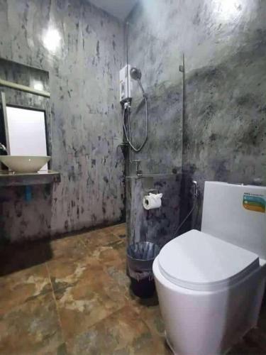 a bathroom with a toilet and a sink at Laila Places at Lanta in Ko Lanta