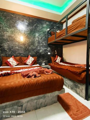 a bedroom with two bunk beds and a mural at Laila Places at Lanta in Ko Lanta