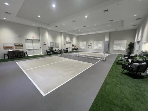 a tennis court in a room with a tennis racket at LIC Mgr - MODERN 4 BED 4 BATH VILLA - UPSCALE OCEANFRONT RESORT - INDOOR PICKLEBALL - SPEAKEASY! in Key Largo