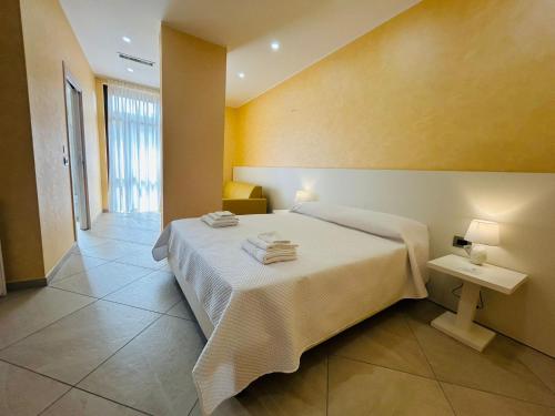 a bedroom with a bed with towels on it at Nuovo Borgo B&B in Campogrande