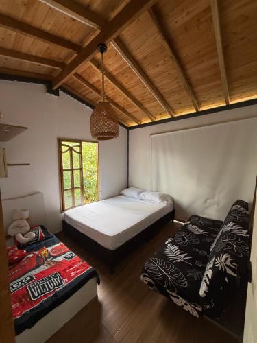 a bedroom with two beds and a window at Espectacular Casa-Bonobohouse al lado del rio con reserva natural in Acacías