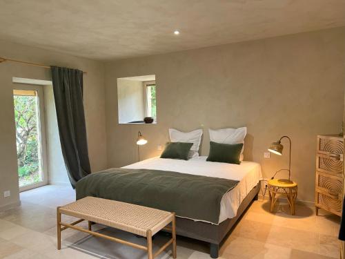 a bedroom with a large bed and a window at La longère de Sarlat in Sarlat-la-Canéda