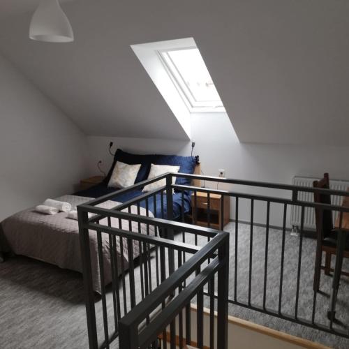 a bedroom with a bed and a stair railing at Agroturystyka Relax na Kaszubach in Żuromino