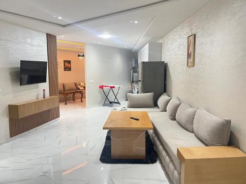 a living room with a couch and a table at Real appartement in El Jadida