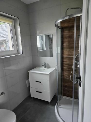 a bathroom with a sink and a shower at Agroturystyka Relax na Kaszubach in Żuromino