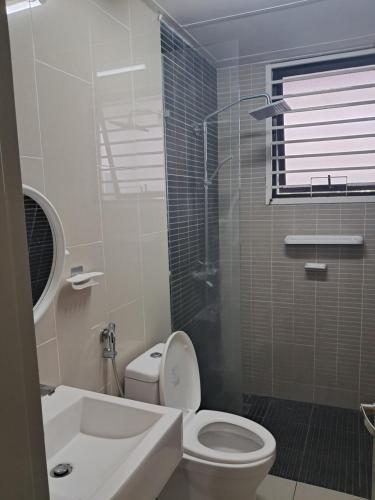 a bathroom with a toilet and a sink and a shower at Homestay Putrajaya Ayer 8 Elzahra Suites With Wi Fi in Putrajaya