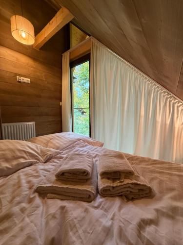 a bedroom with a bed with towels on it at Beskidzkie Wyspy in Tenczyn