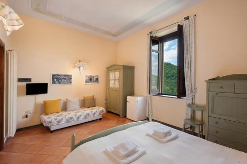 Ένα ή περισσότερα κρεβάτια σε δωμάτιο στο Camere familiari in Agriturismo