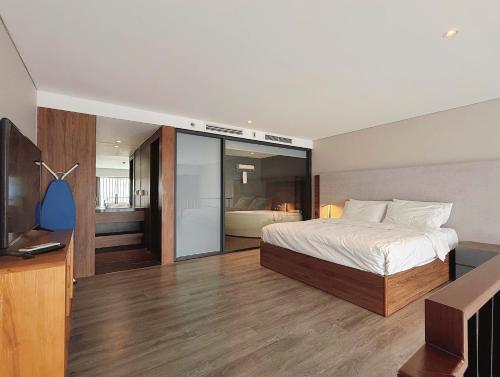 a bedroom with a bed and a flat screen tv at Westlake view condominium in Hanoi