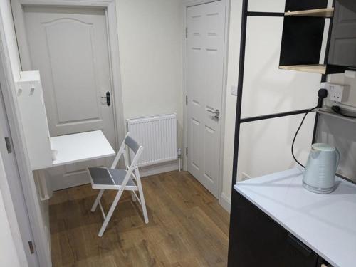 a kitchen with a desk and a chair in a room at Stylish Self Contained Unit - High Wycombe in High Wycombe